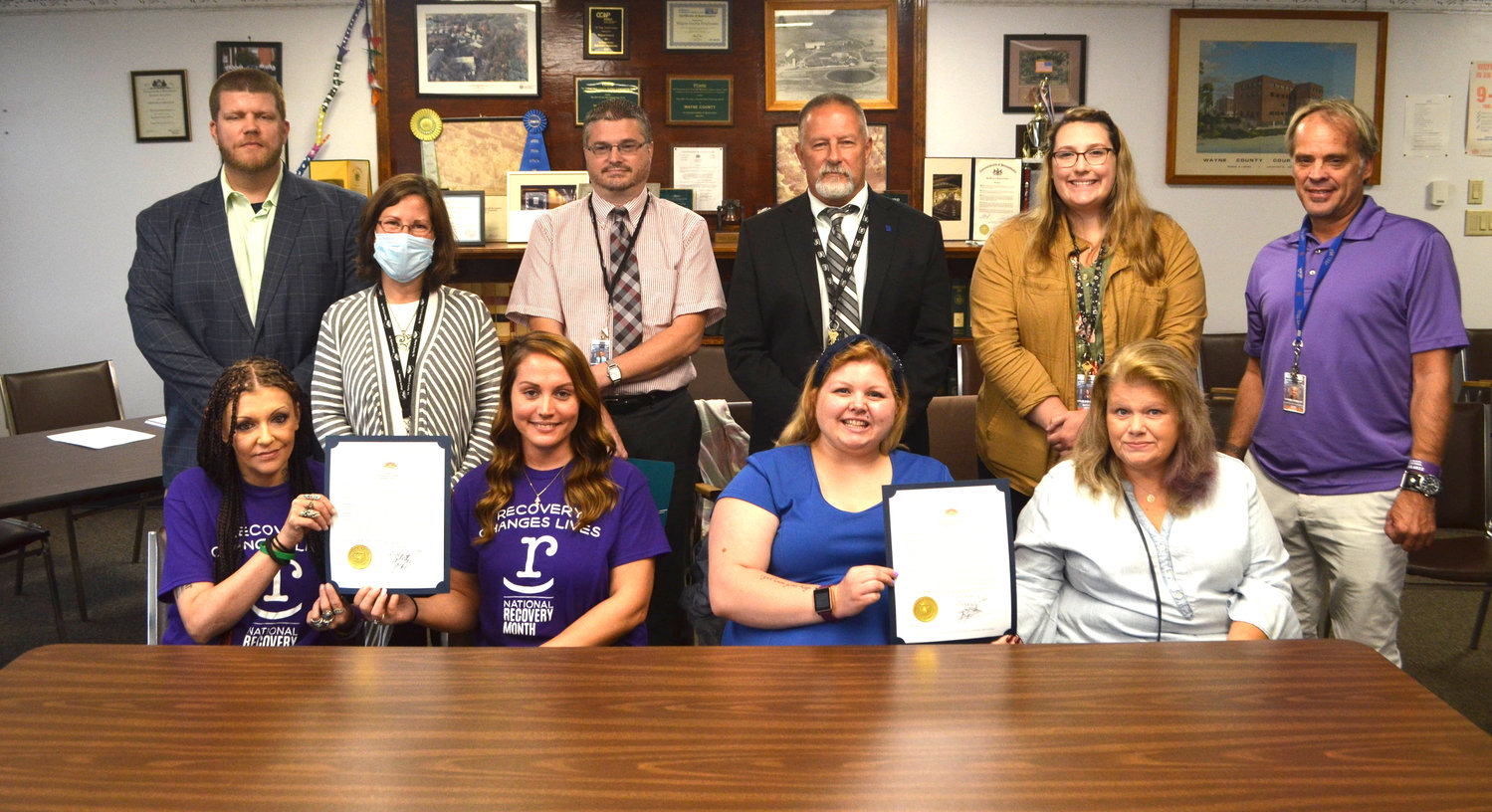 Gathered together to proclaim National Recovery Month were Autumn DeLong-VanDerhoff, seated left, Kelly Wietry, Bonnie Smith, Carolyn Smith, Steve Bair, standing left, Jocelyn Cramer, Jeff Zerechak, Brian Smith, Kylie Emerson, and Jim Simpson.